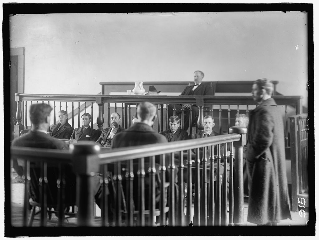 Re-enactment of shooting for the 2nd trial. Harris & Ewing, photographer. FEUD. SCENES IN VIRGINIA MOUNTAIN TOWN AT TRIAL AFTER FEUD. United States Carroll County Hillsville Virginia, 1912. Photograph. https://www.loc.gov/item/2016884015/.